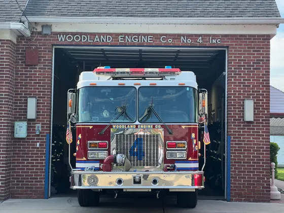 Engine 4 in the apparatus bay at 20 Driscoll Avenue, beneath the Woodland Engine Co. No. 4 sign