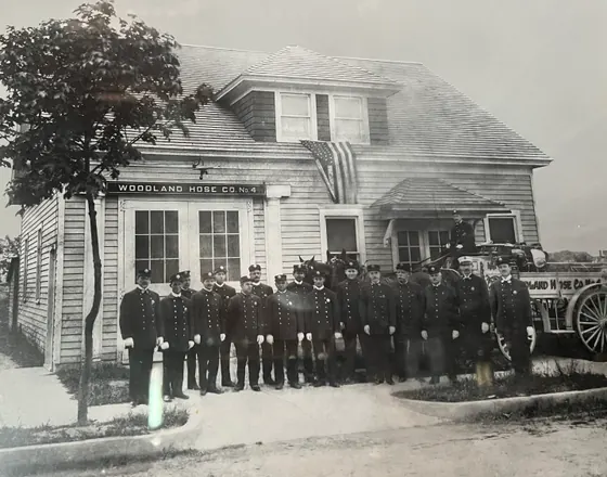Woodland members in dress uniform with the company’s horse-drawn apparatus, circa 1912